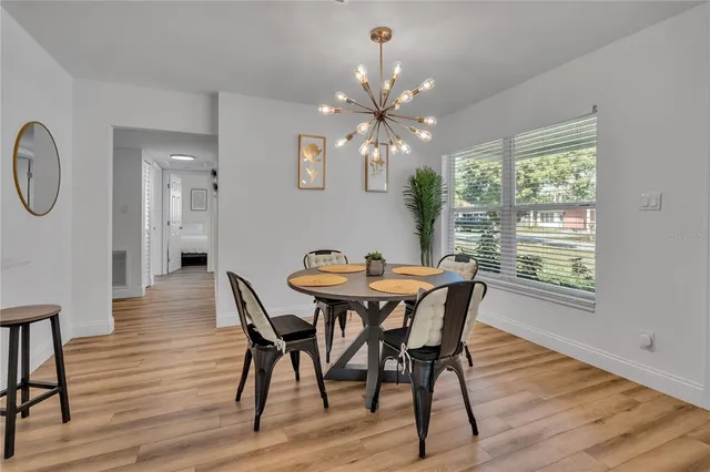 a view of a dining room with furniture window and wooden floor