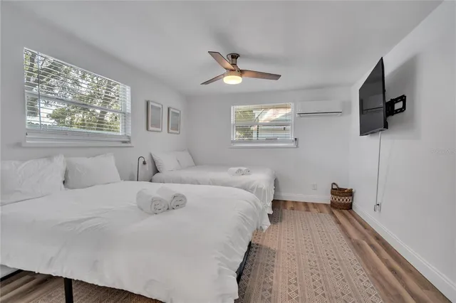 a bedroom with a bed and a chandelier