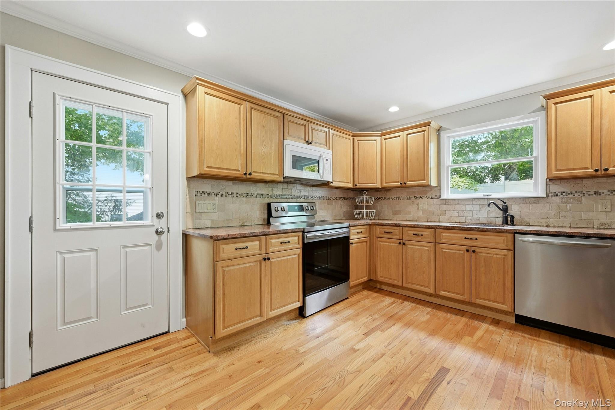 15 Birch Road Rocky Point, NY 11778 - Photo 7 of 30 Kitchen with stainless steel appliances, door to the deck
