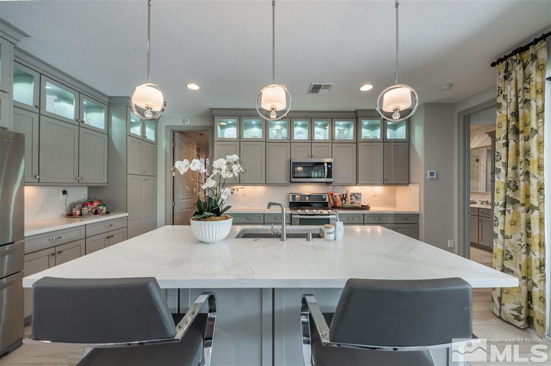 9920 Hafflinger Lane Reno, NV 89521 - Photo 11 of 36 a view of a dining room and chandelier fan