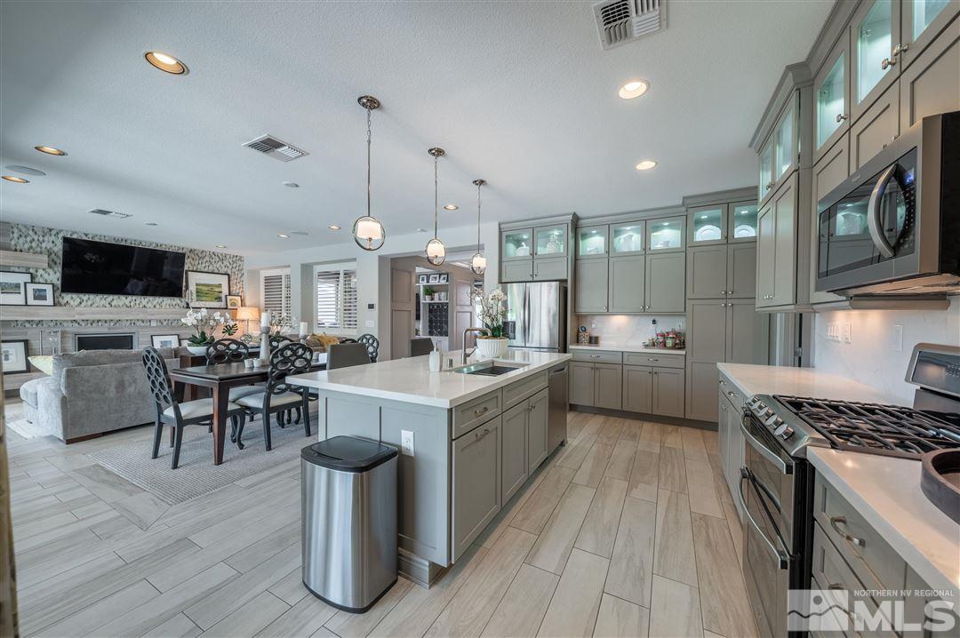 9920 Hafflinger Lane Reno, NV 89521 - Photo 14 of 36 a kitchen with lots of counter top space and stainless steel appliances