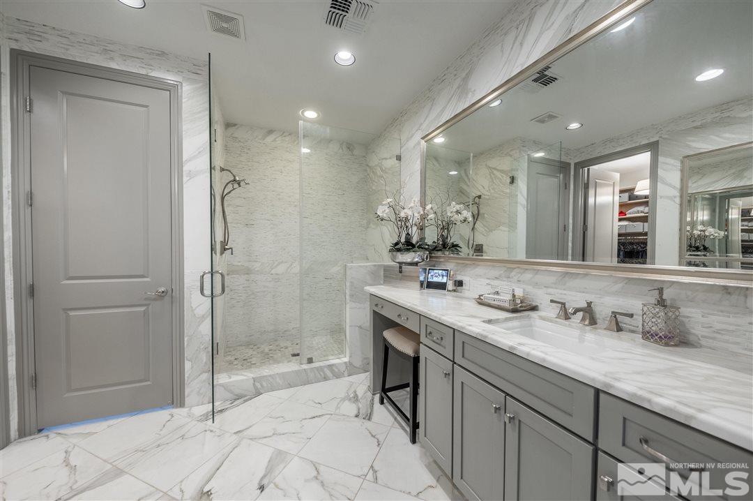 9920 Hafflinger Lane Reno, NV 89521 - Photo 18 of 36 a bathroom with a granite countertop sink mirror and shower