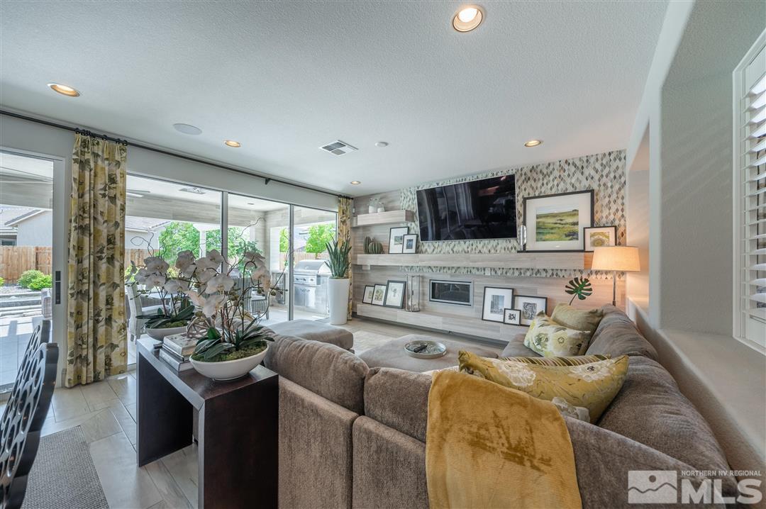 9920 Hafflinger Lane Reno, NV 89521 - Photo 10 of 36 a living room with furniture and a flat screen tv