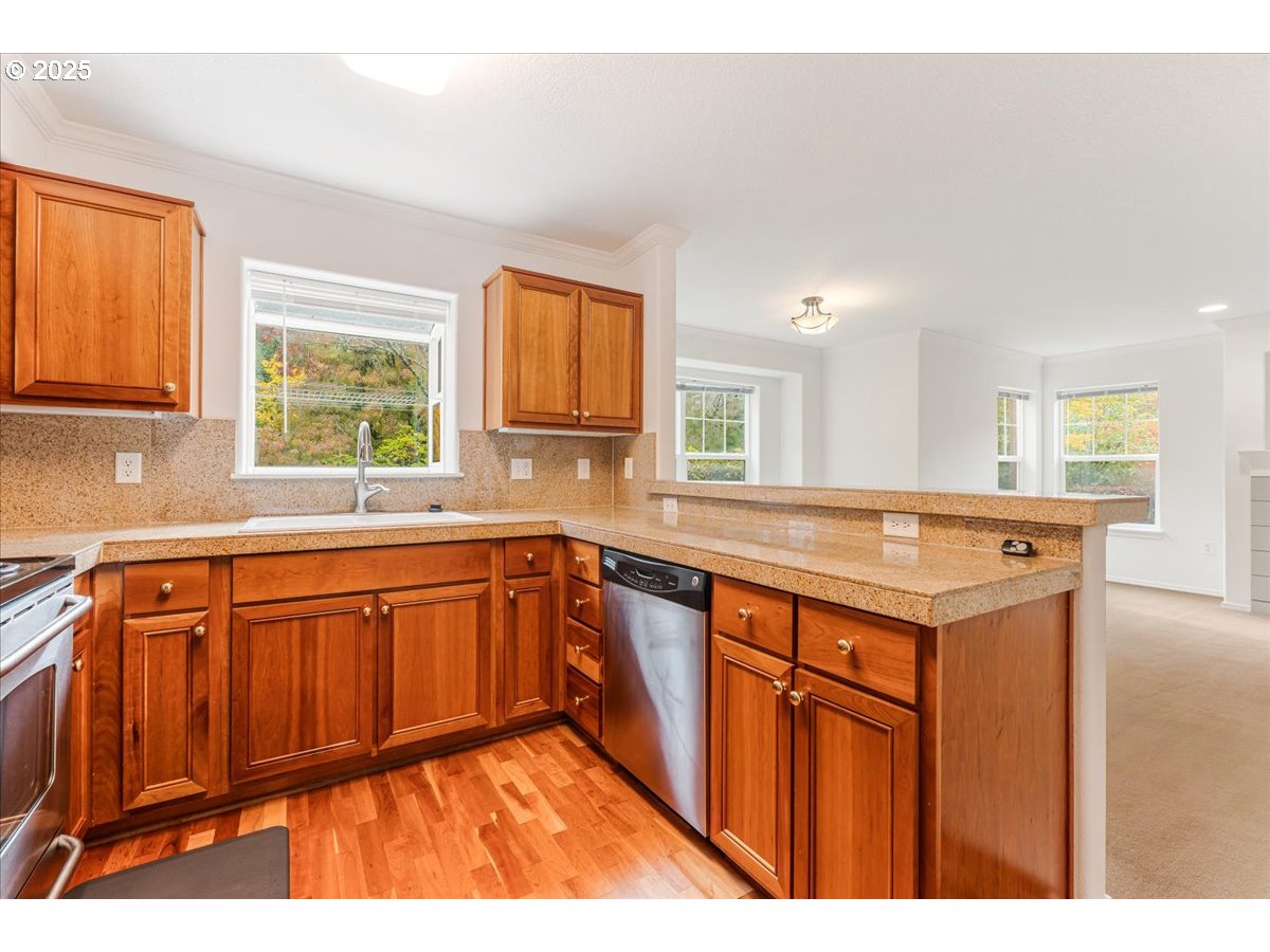 30424 Southwest Ruth Street, Unit 84 Wilsonville, OR 97070 - Photo 13 of 48 a kitchen with stainless steel appliances granite countertop a sink stove and cabinets