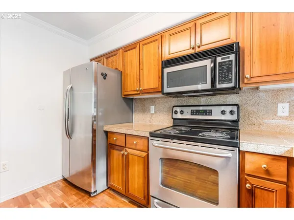a kitchen with stainless steel appliances granite countertop a stove microwave and refrigerator