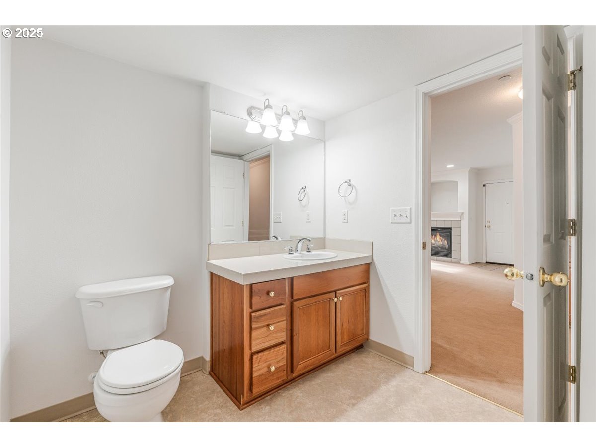30424 Southwest Ruth Street, Unit 84 Wilsonville, OR 97070 - Photo 17 of 48 a bathroom with a toilet sink vanity granite and mirror