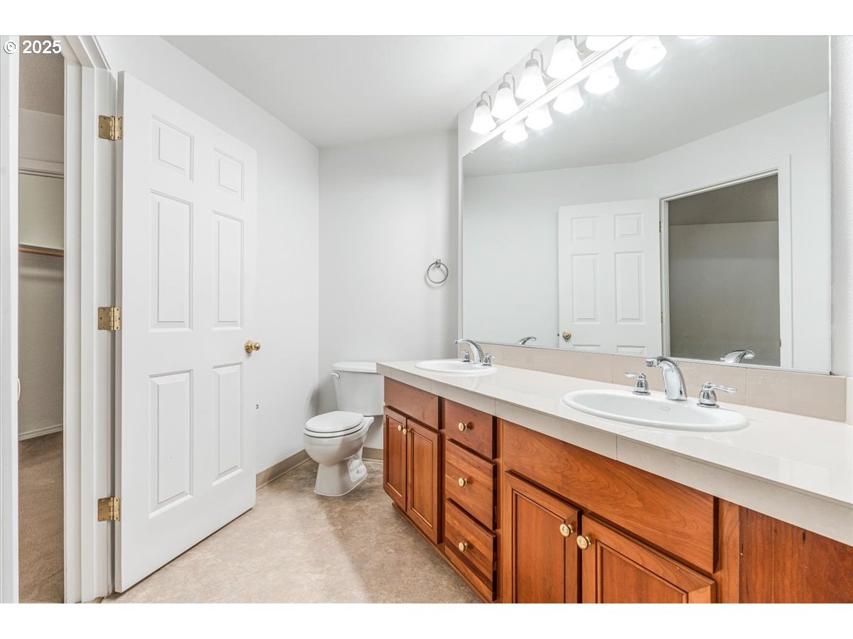 30424 Southwest Ruth Street, Unit 84 Wilsonville, OR 97070 - Photo 24 of 48 a spacious bathroom with a double vanity sink mirror and toilet