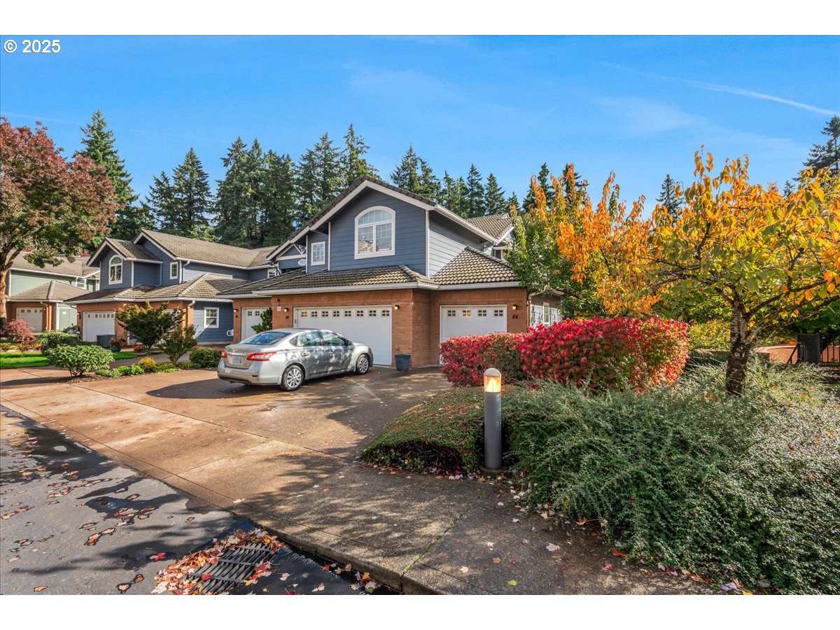 30424 Southwest Ruth Street, Unit 84 Wilsonville, OR 97070 - Photo 3 of 48 a front view of a house with a yard and garage