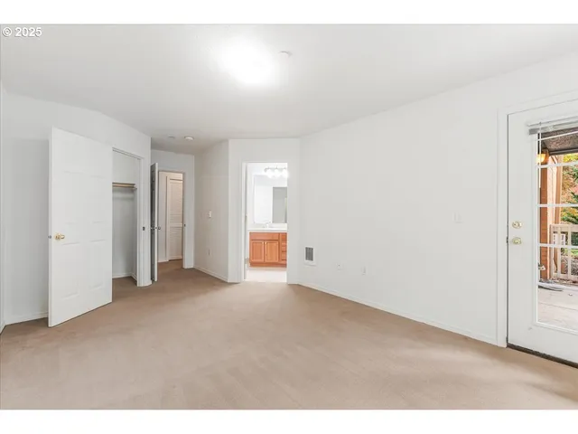 a view of an empty room and a window