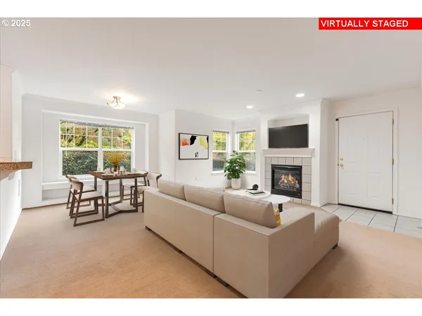 a living room with furniture fireplace and window