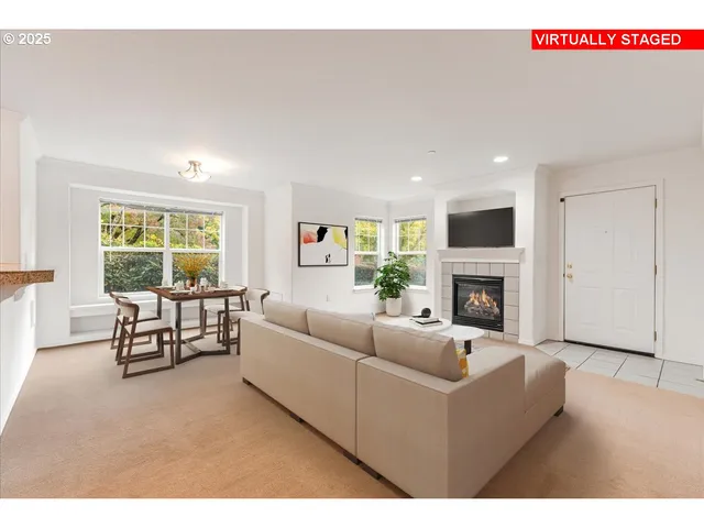a living room with furniture fireplace and window