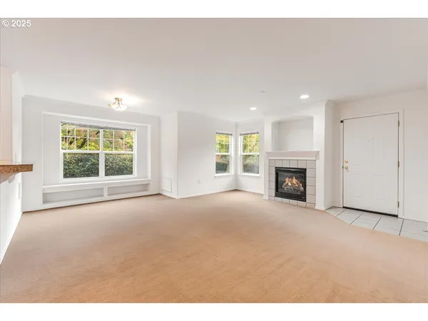 a view of empty room with a fireplace
