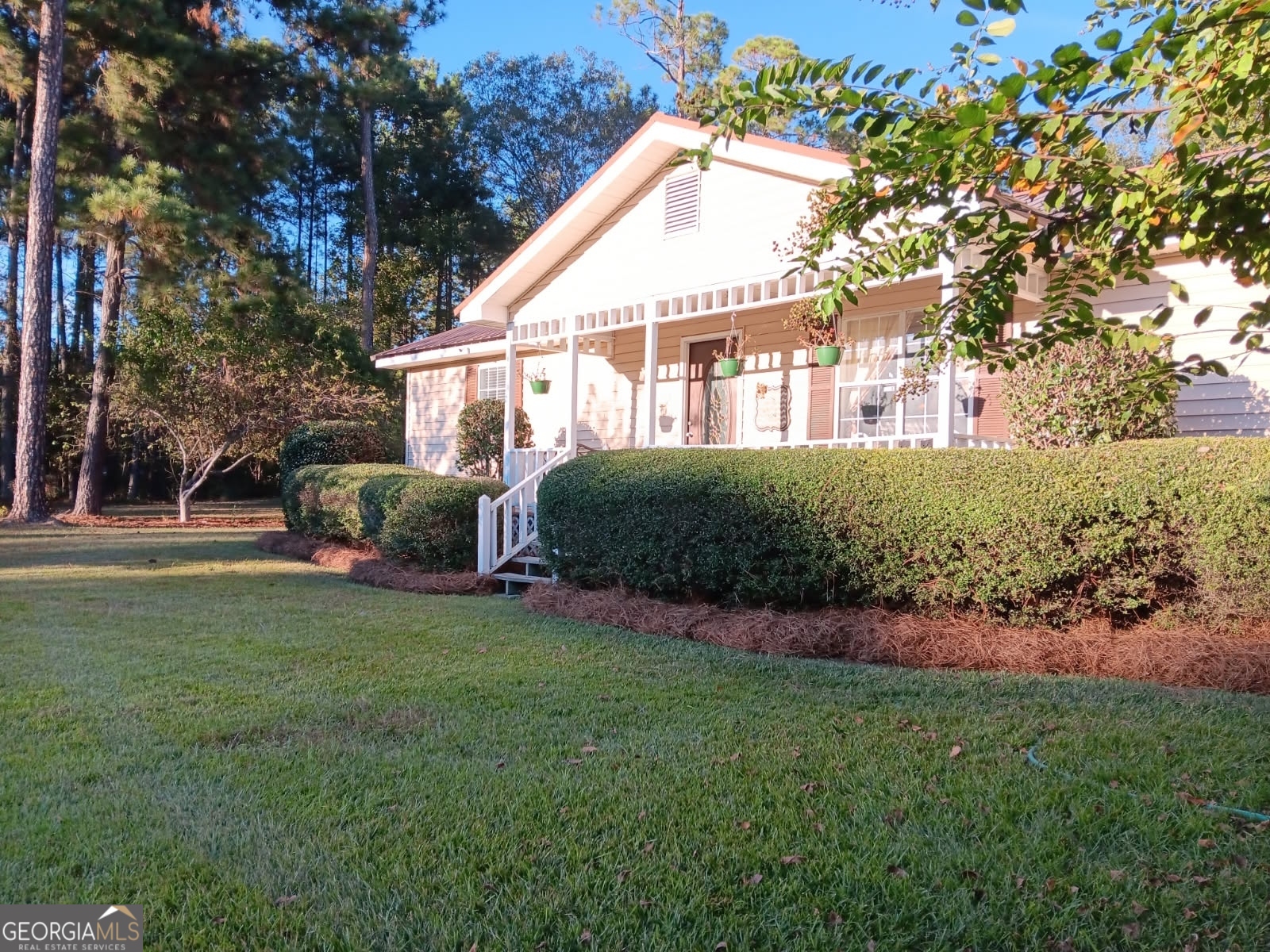 a front view of a house with a garden