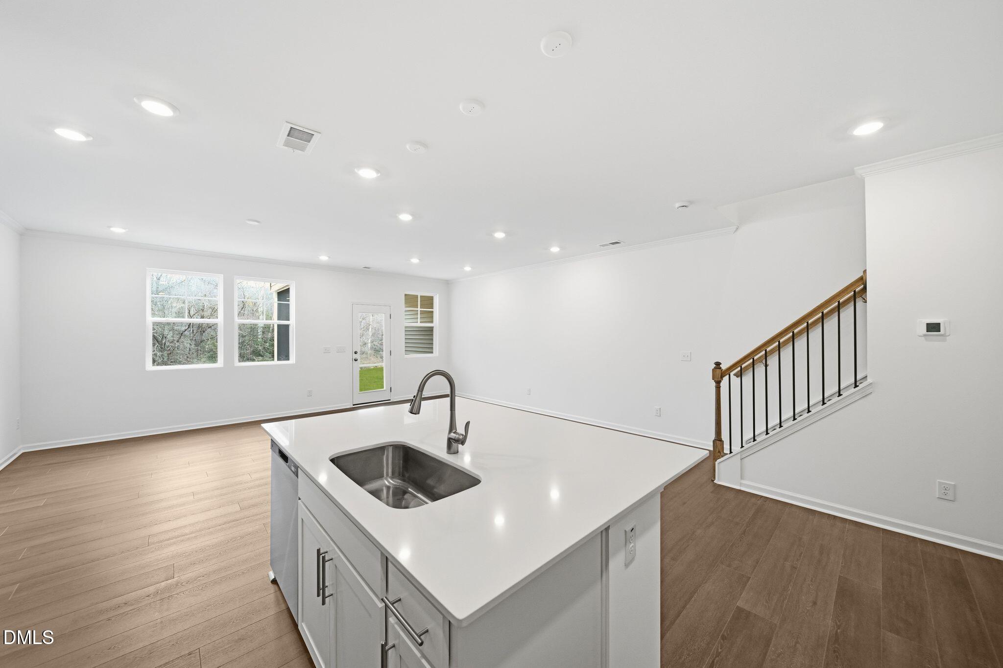 2946 Hickory Fld Drive Raleigh, NC 27616 - Photo 12 of 30 a kitchen with stainless steel appliances granite countertop a sink and a white countertops with wooden floor