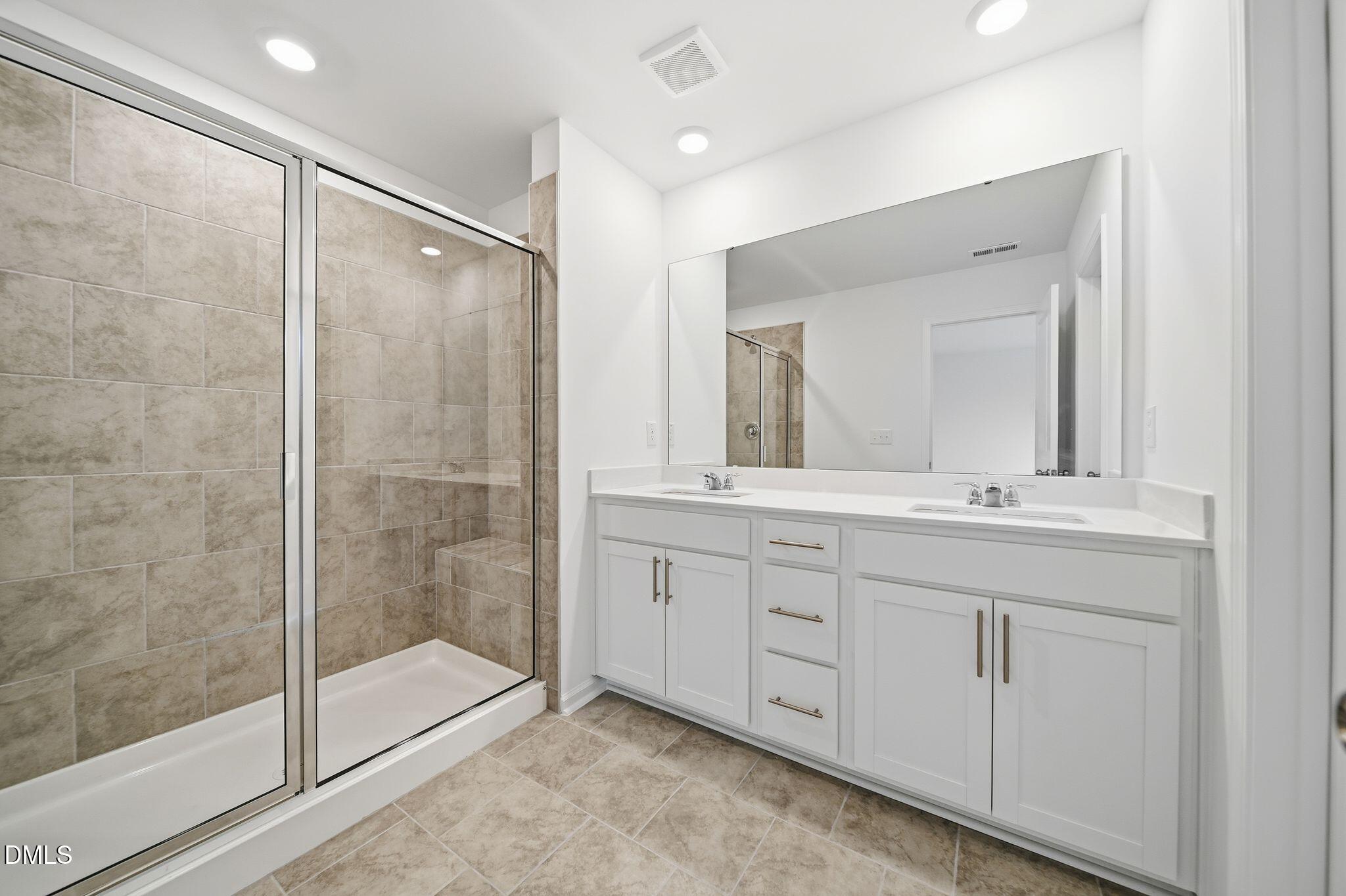 2946 Hickory Fld Drive Raleigh, NC 27616 - Photo 24 of 30 a bathroom with a shower sink and mirror