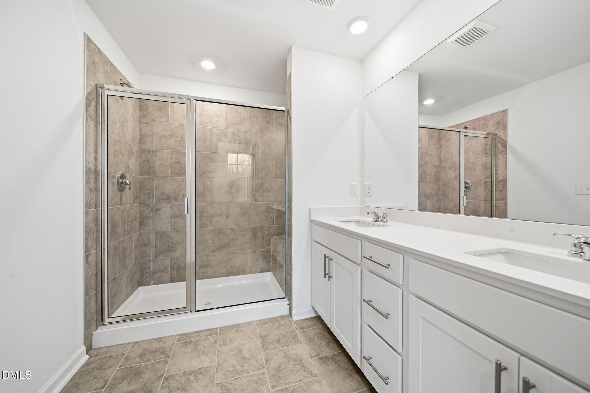 2946 Hickory Fld Drive Raleigh, NC 27616 - Photo 25 of 30 a spacious bathroom with a shower sink and mirror