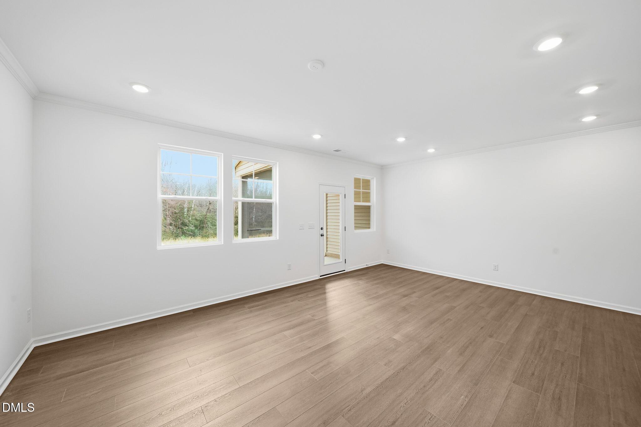 2946 Hickory Fld Drive Raleigh, NC 27616 - Photo 5 of 30 an empty room with wooden floor and windows