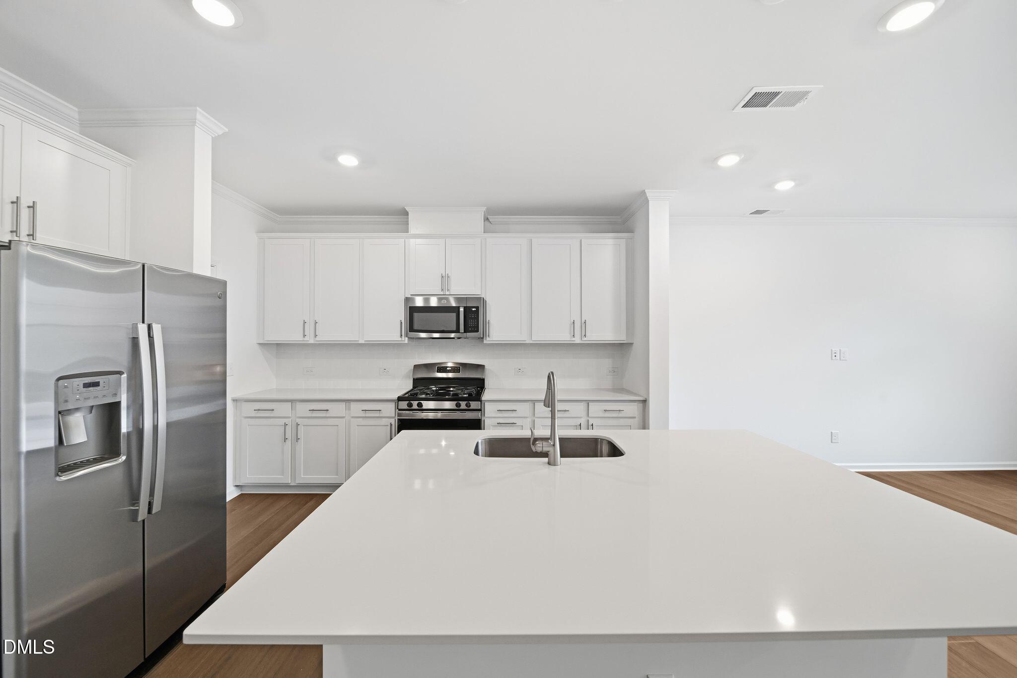 2946 Hickory Fld Drive Raleigh, NC 27616 - Photo 8 of 30 a kitchen with stainless steel appliances a refrigerator stove microwave and cabinets