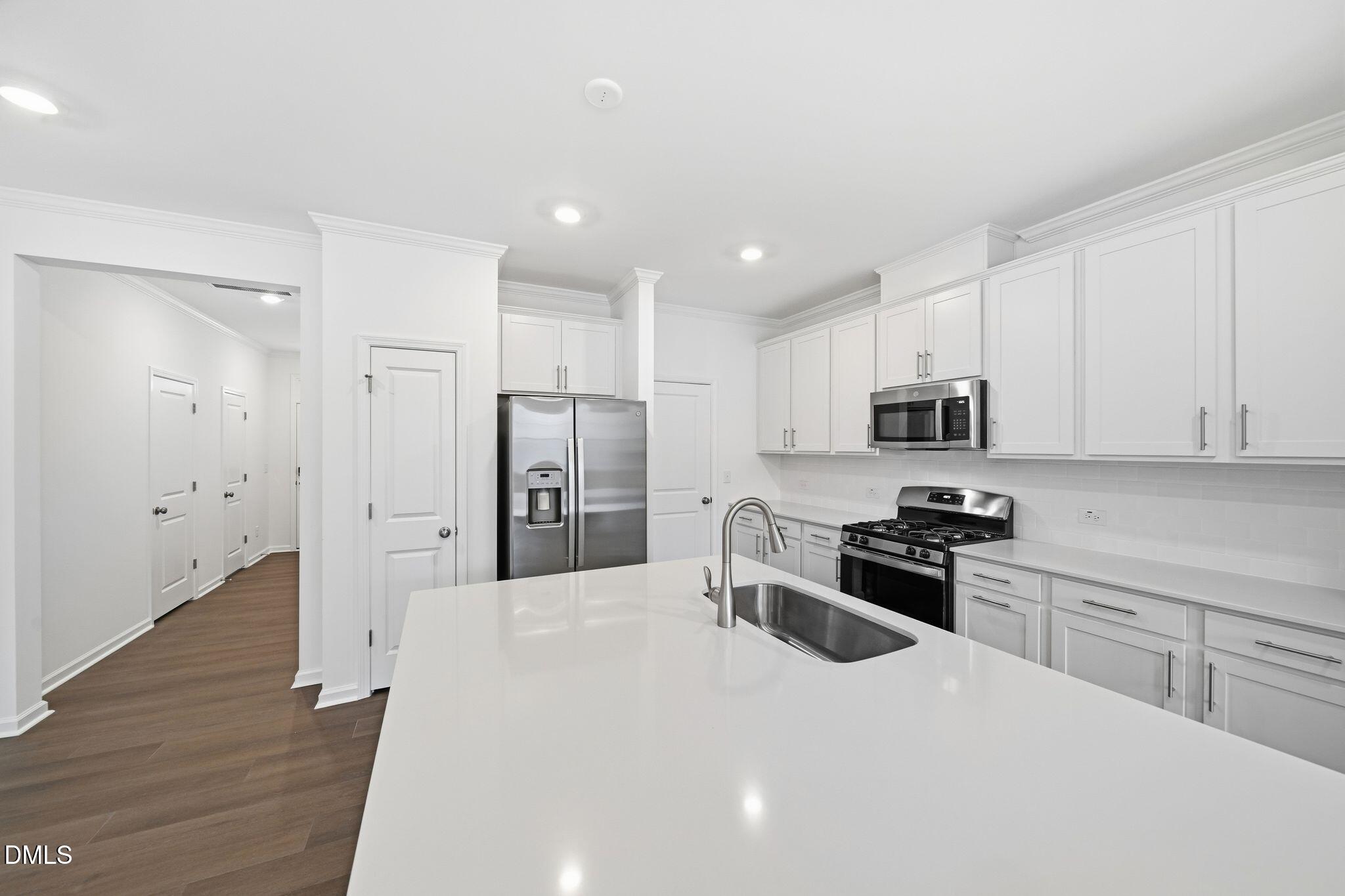 2946 Hickory Fld Drive Raleigh, NC 27616 - Photo 9 of 30 a kitchen with stainless steel appliances a refrigerator stove microwave and cabinets