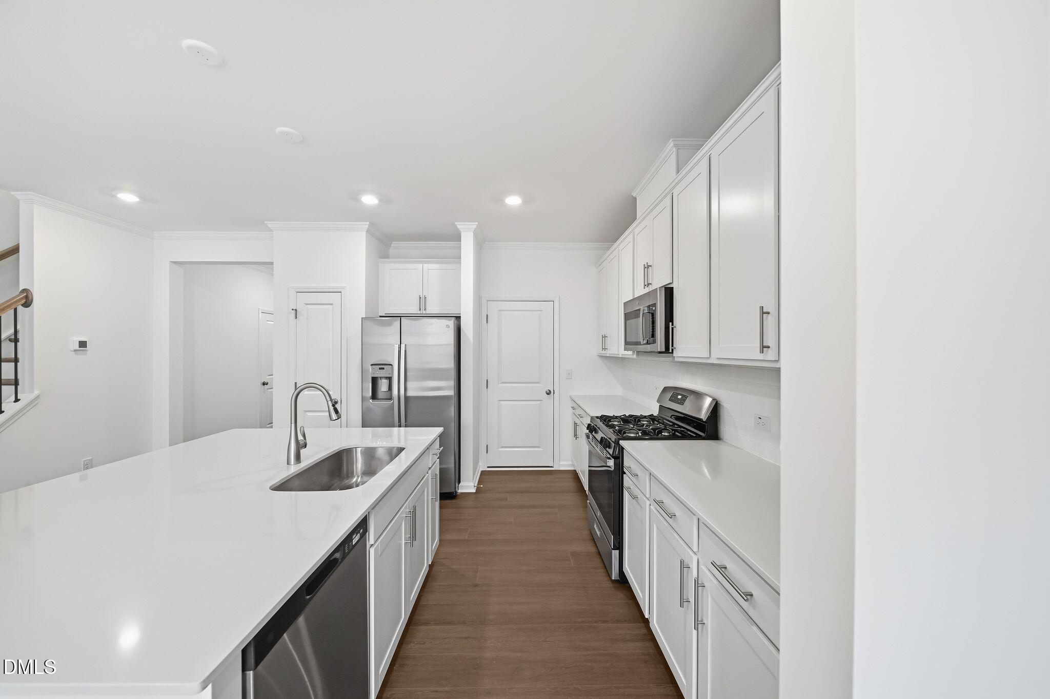 2946 Hickory Fld Drive Raleigh, NC 27616 - Photo 10 of 30 a kitchen with stainless steel appliances a sink stove and cabinets