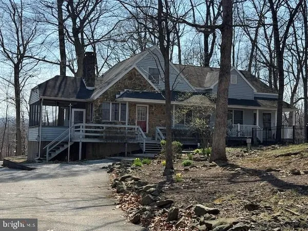 a house that has a tree in front of it