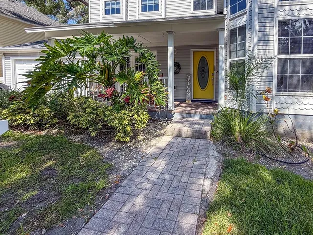 a balcony with chairs and with plants