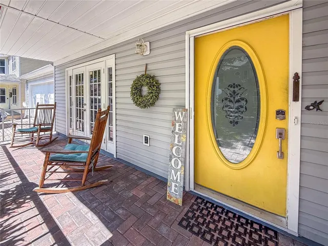 a living room with furniture a piano and a large window