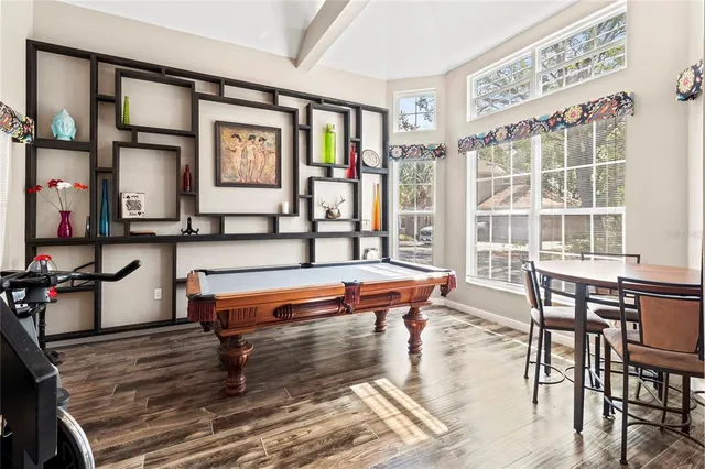 a view of a livingroom with furniture wooden floor and window