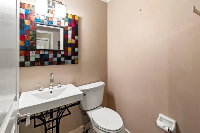 a kitchen with stainless steel appliances granite countertop a kitchen island hardwood floor sink stove and refrigerator