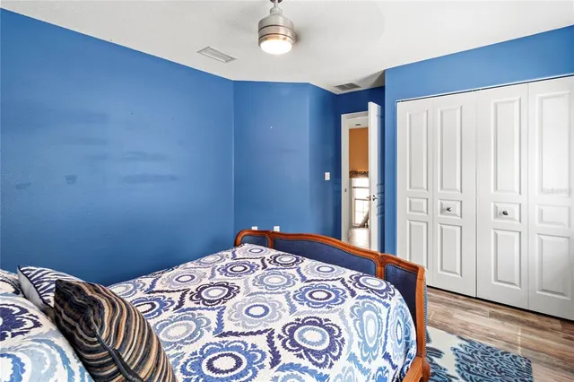 a bedroom with a bed and a chandelier