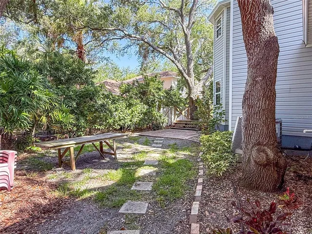 a view of a house with backyard and sitting area