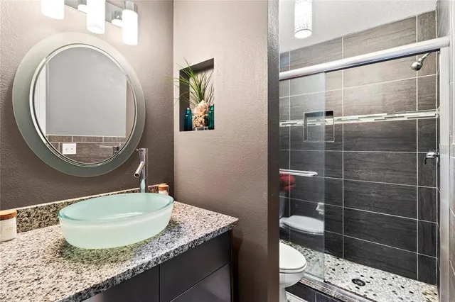 a view of a house with a small yard plants and large tree