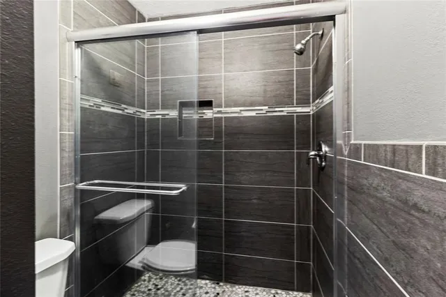a view of a patio with a table and chairs under an umbrella
