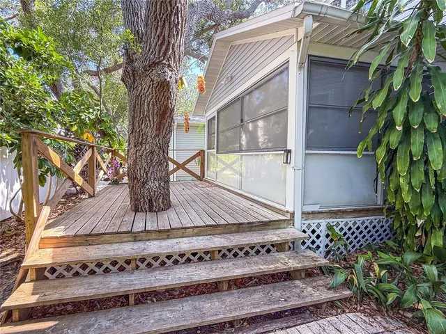 a view of balcony with wooden floor and outdoor seating