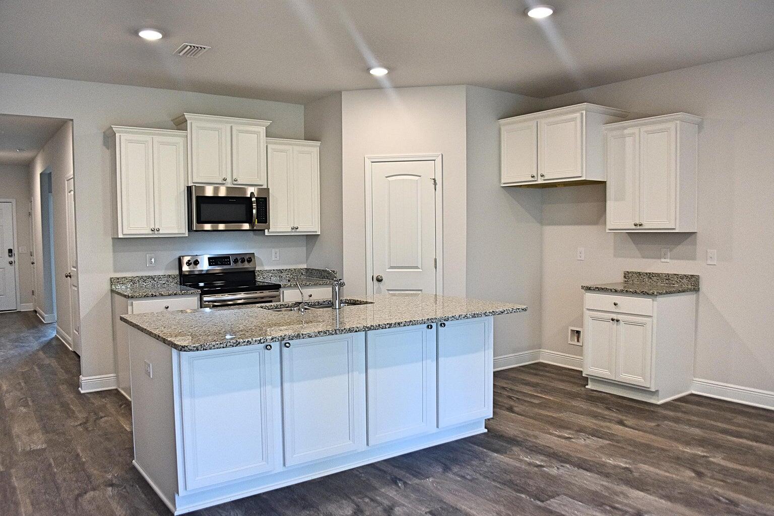 131 Southern Pnes Road Santa Rosa Beach, FL 32459 - Photo 4 of 4 a kitchen with stainless steel appliances a stove a sink and white cabinets