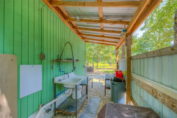a view of a porch with furniture and a yard
