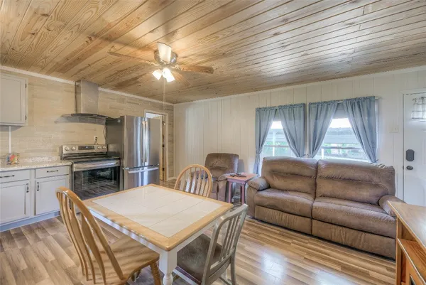 a living room with furniture a dining table and kitchen view