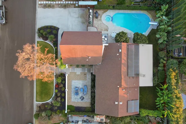 an aerial view of a house with yard swimming pool and outdoor seating