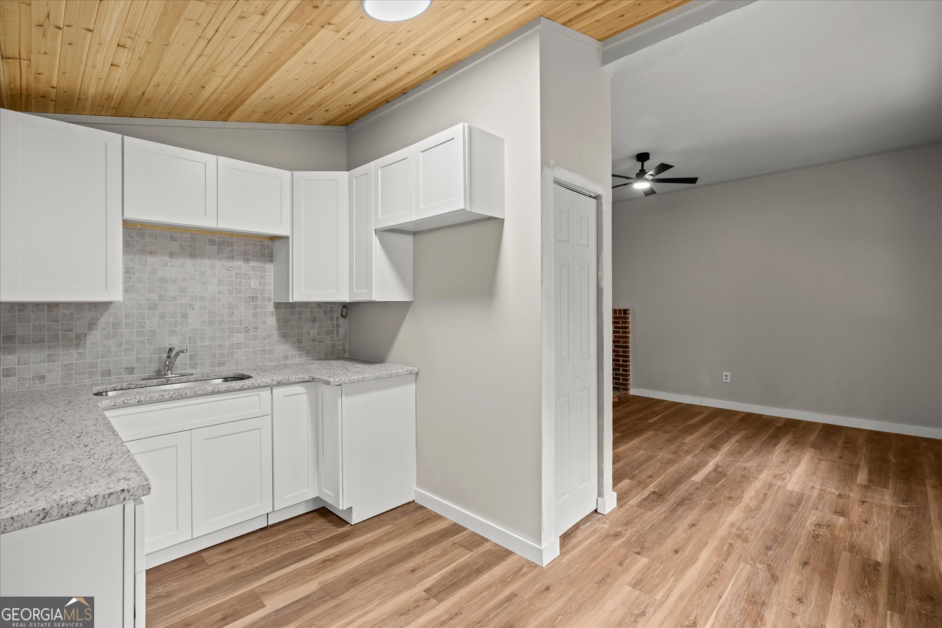 3102 McKenzie Road East Point, GA 30344 - Photo 11 of 31 a kitchen with a sink a refrigerator and cabinets