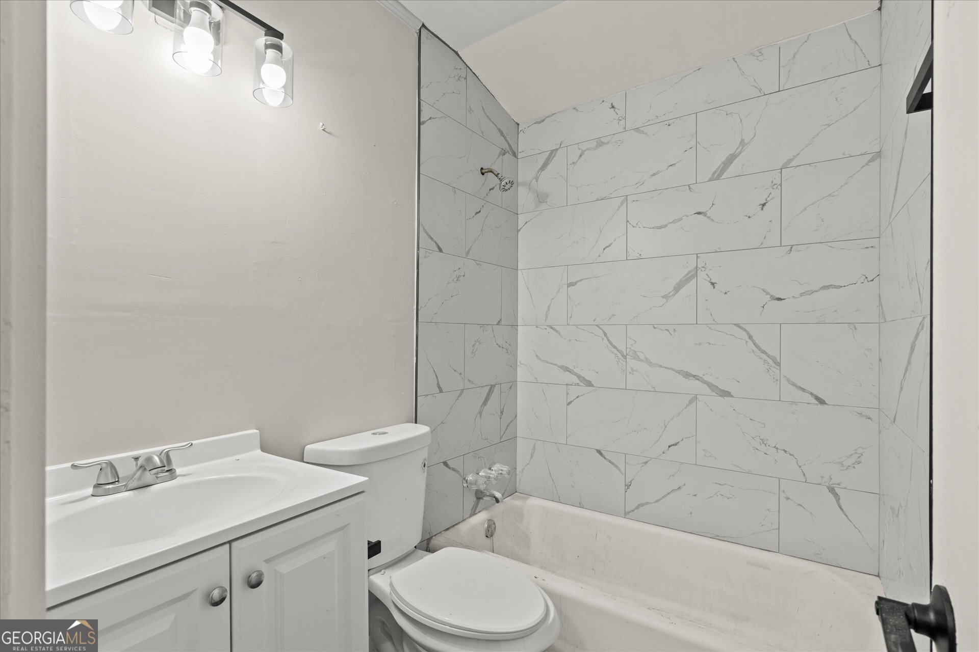 3102 McKenzie Road East Point, GA 30344 - Photo 17 of 31 a bathroom with a sink toilet and shower