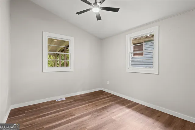 a view of room with window and ceiling fan