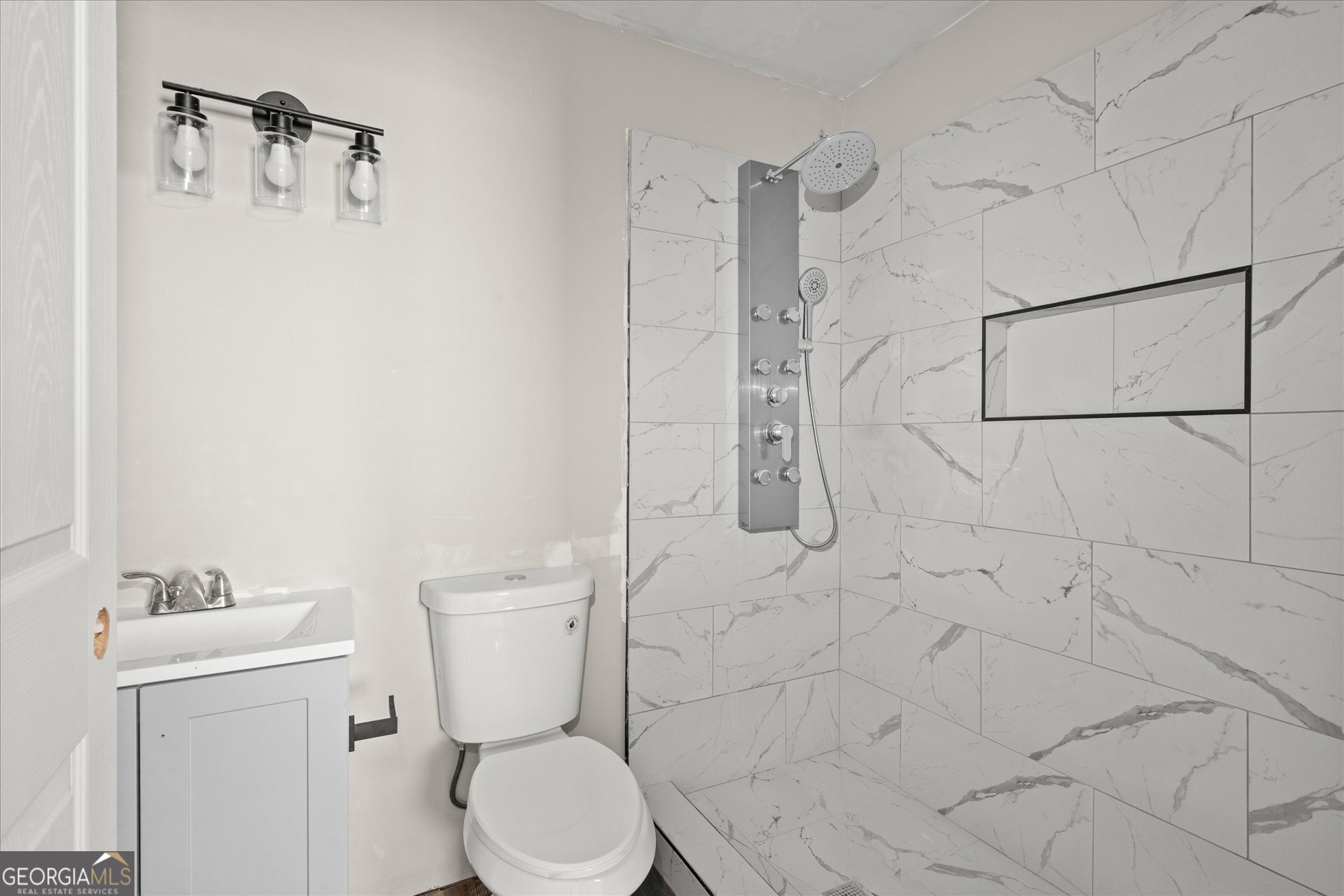 3102 McKenzie Road East Point, GA 30344 - Photo 20 of 31 a white toilet sitting next to a bathroom sink