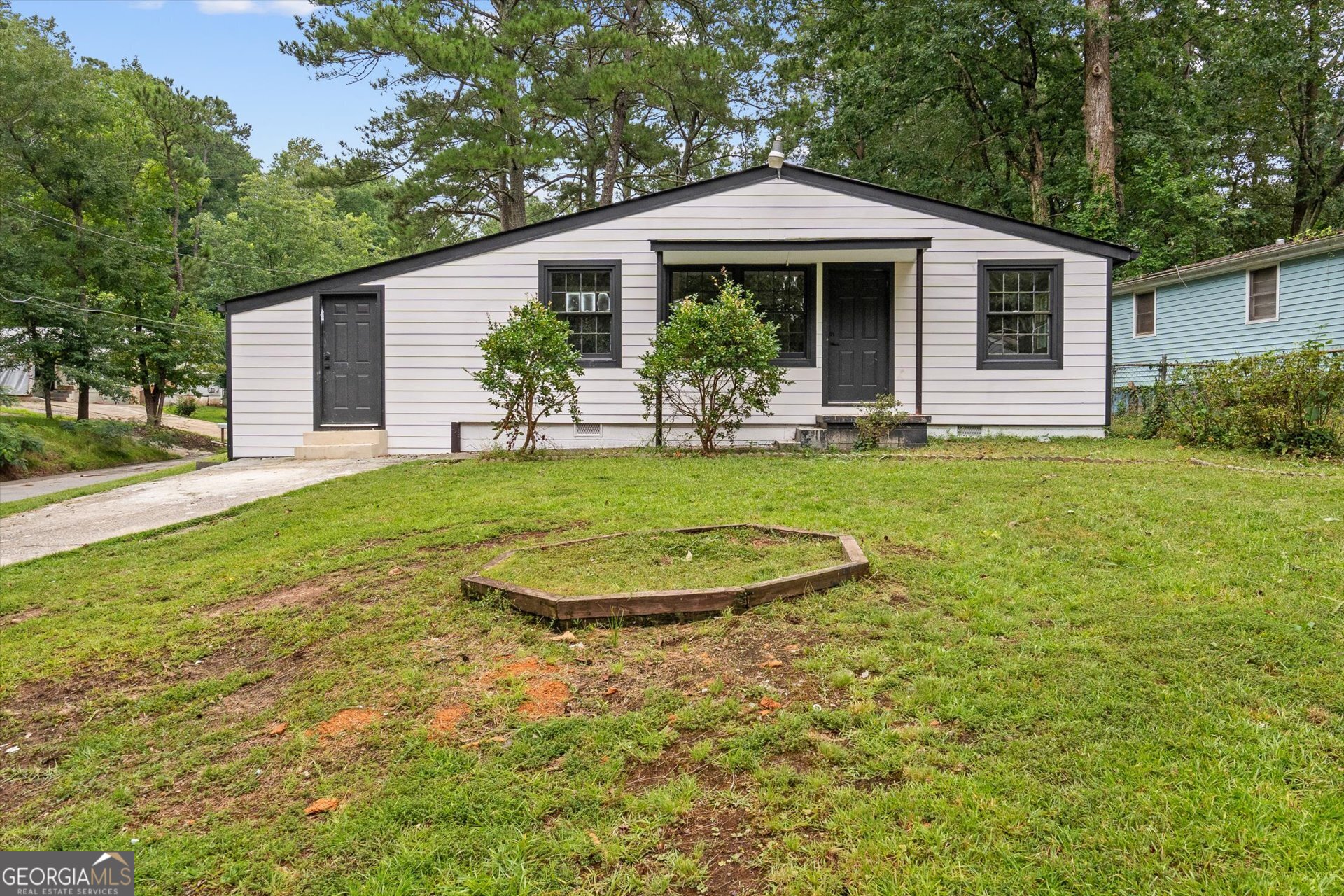3102 McKenzie Road East Point, GA 30344 - Photo 2 of 31 a front view of a house with a yard