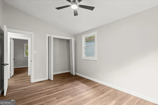 a view of a livingroom with a ceiling fan and wooden floor