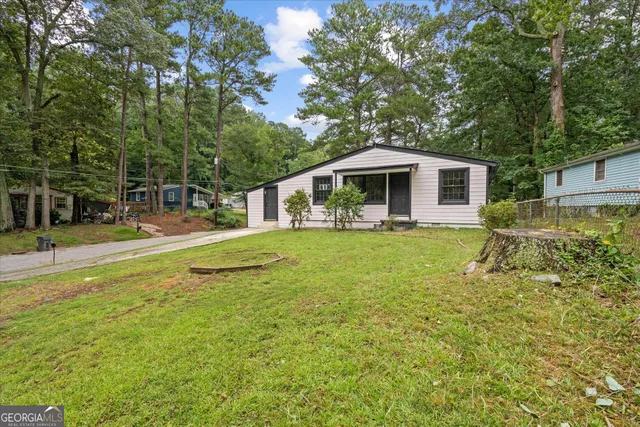 a front view of house with yard and green space