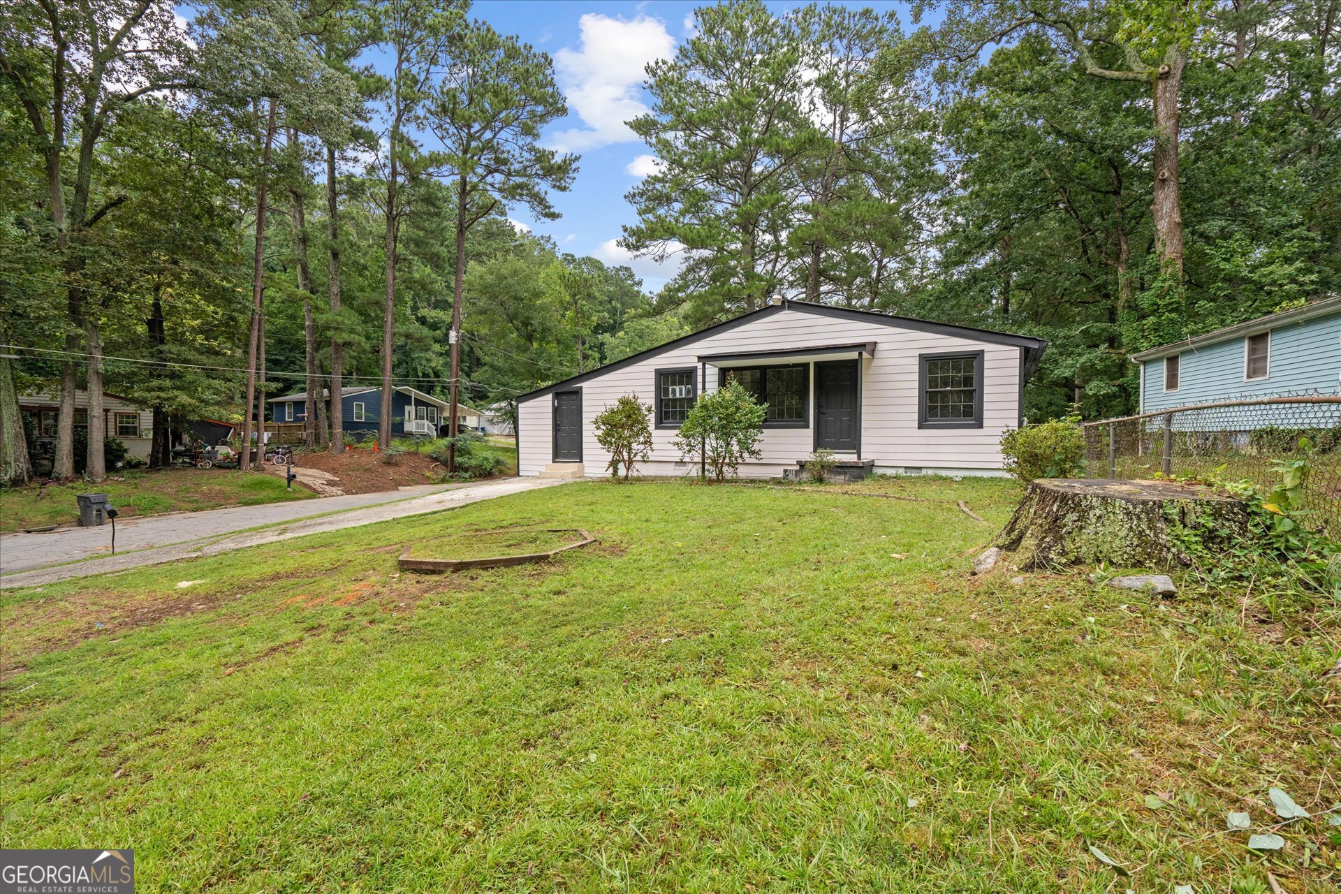 3102 McKenzie Road East Point, GA 30344 - Photo 3 of 31 a front view of house with yard and green space