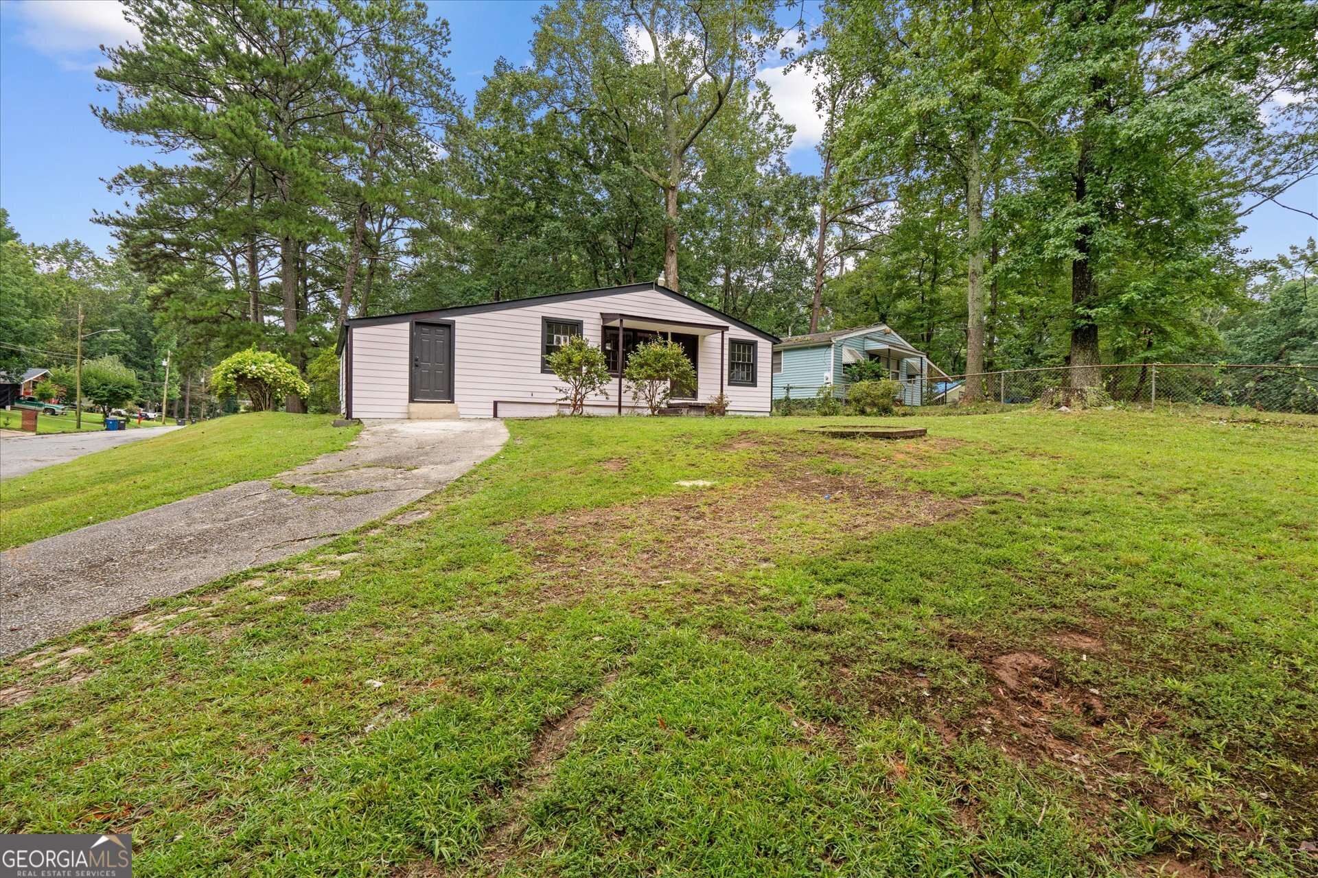 3102 McKenzie Road East Point, GA 30344 - Photo 4 of 31 a front view of a house with a yard