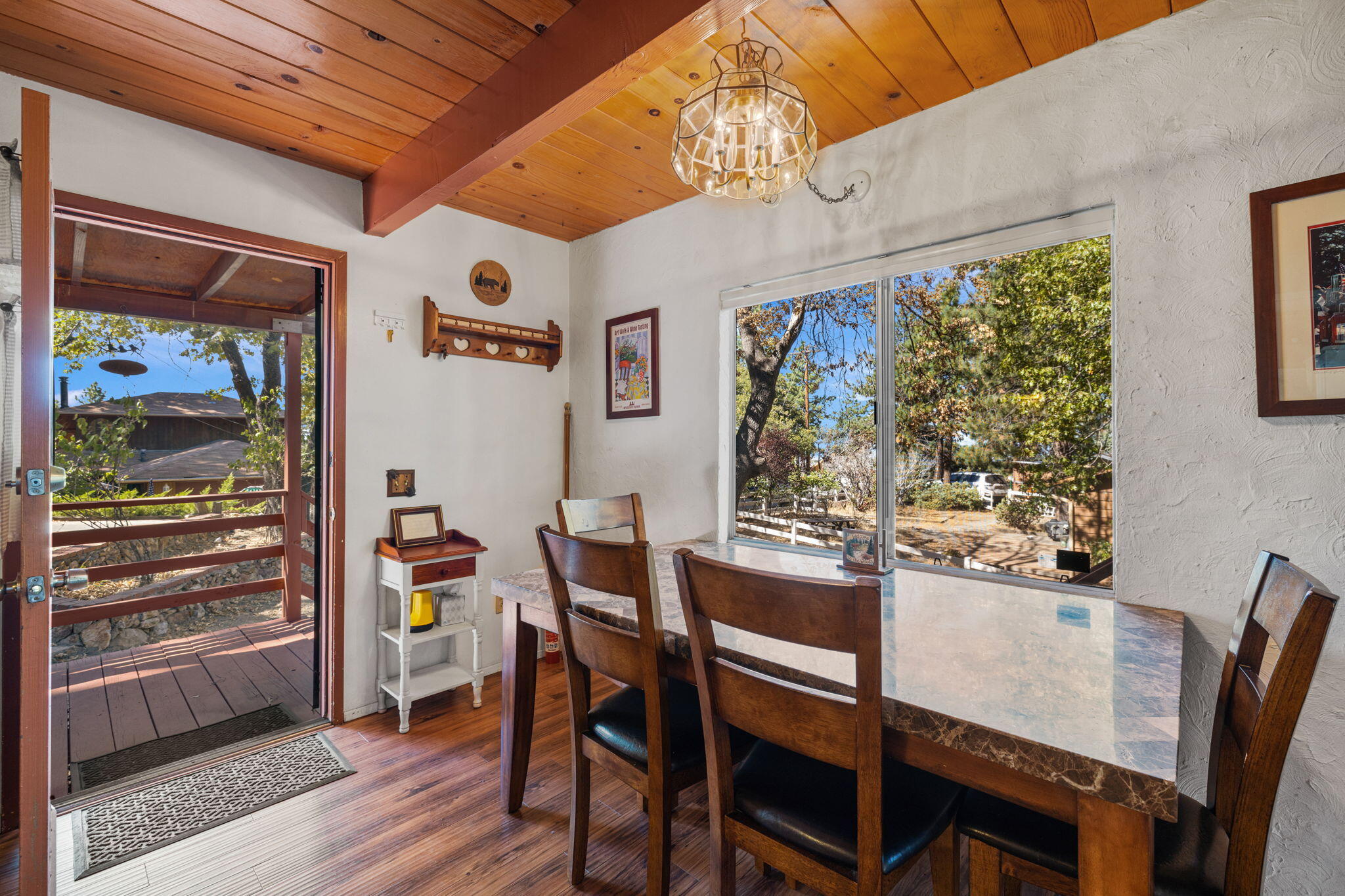 54370 Valley-View Idyllwild, CA 92549 - Photo 4 of 35 a view of a dining room with furniture window and wooden floor