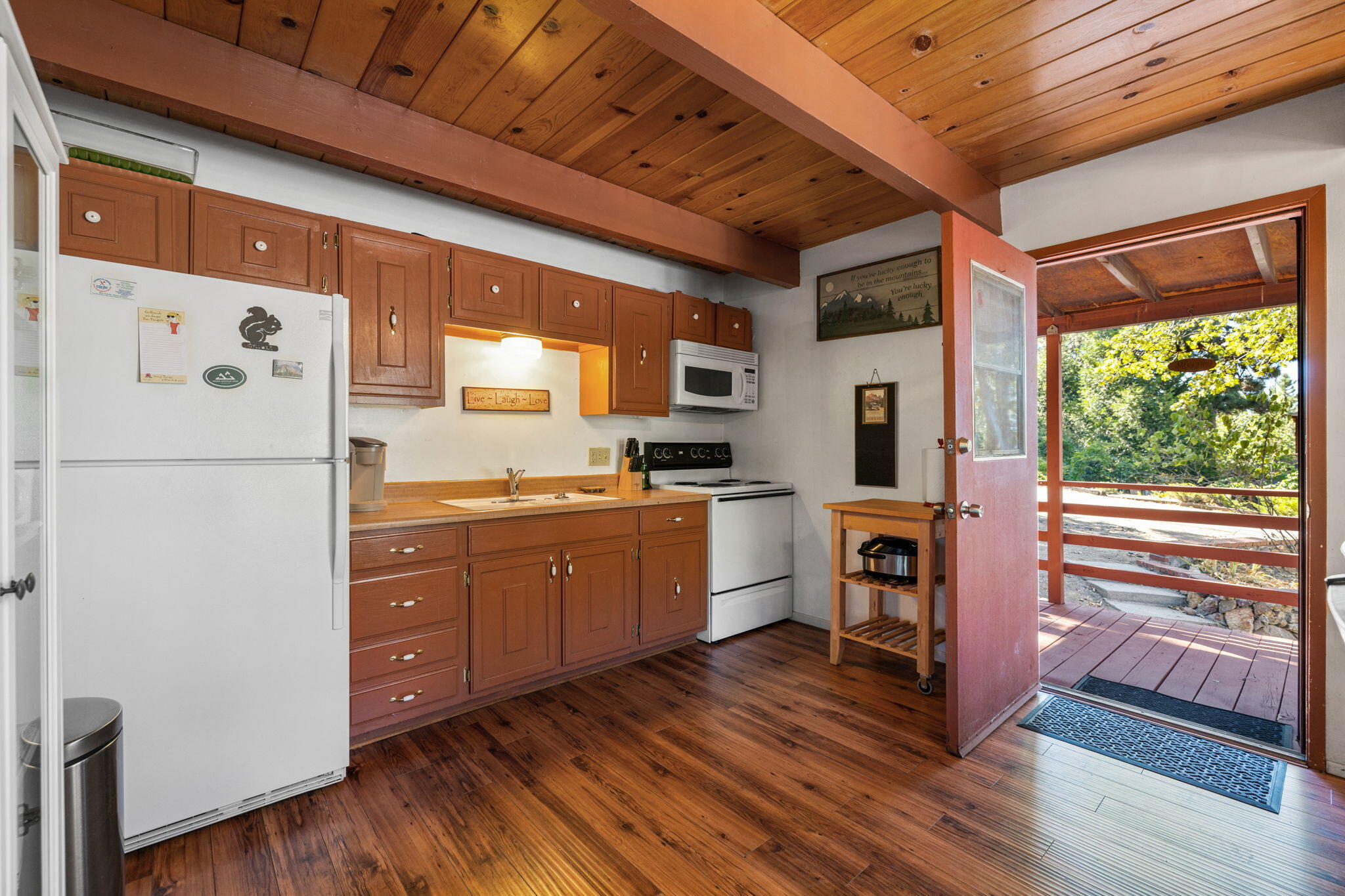 54370 Valley-View Idyllwild, CA 92549 - Photo 6 of 35 a kitchen with sink cabinets and wooden floor