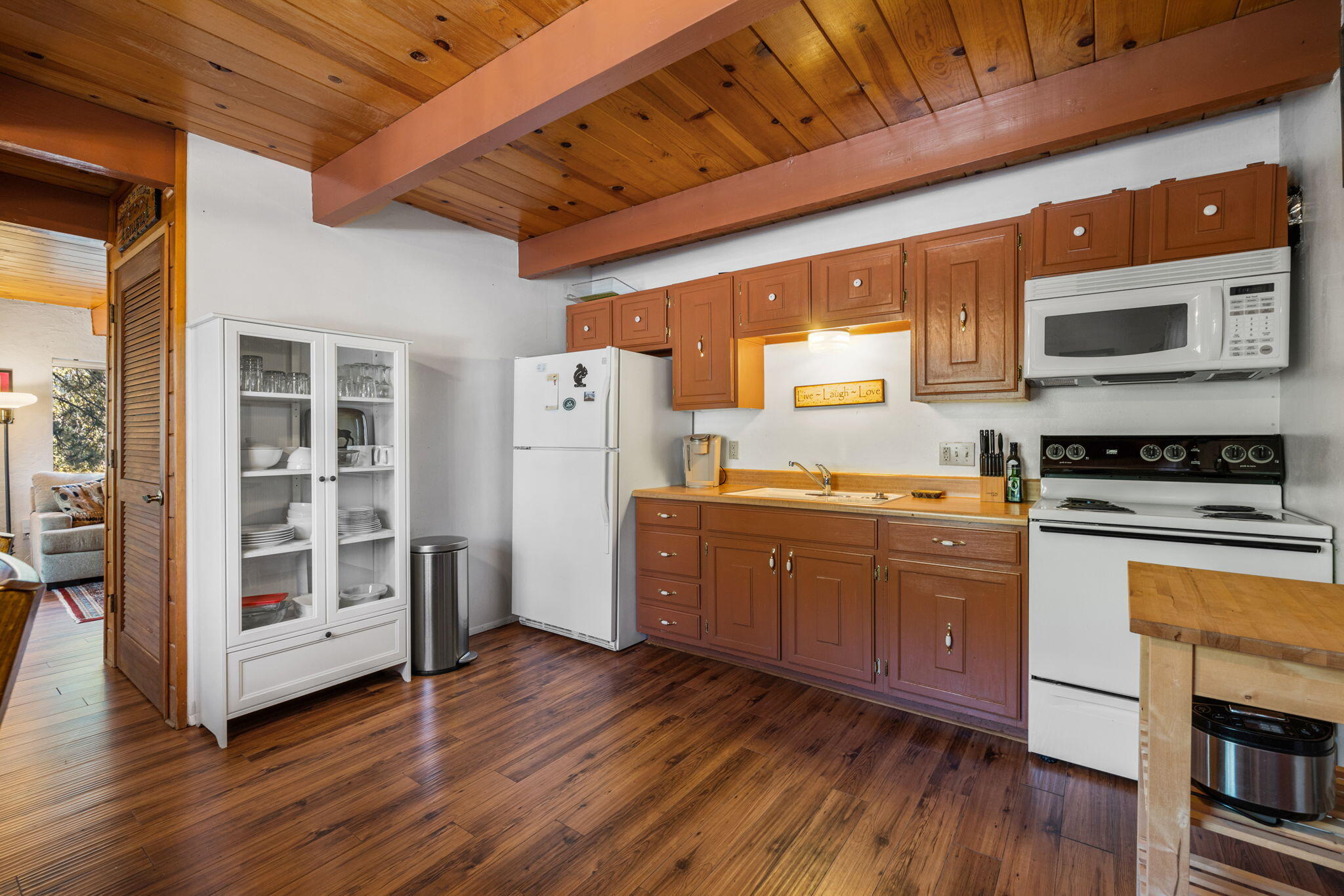 54370 Valley-View Idyllwild, CA 92549 - Photo 7 of 35 a kitchen with sink cabinets and wooden floor